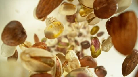 Super slow motion of flying nuts mix in rotating movement. Stock Footage 257536036
