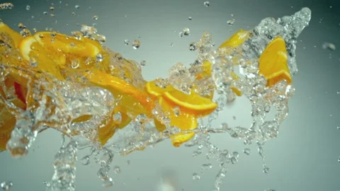 Super Slow Motion of Flying Orange Slices with Water Splashes Stock Footage 281559295
