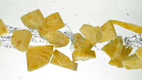 Super Slow Motion of Flying Pineapple Slices in Water Splashes. Stock Footage 303371582