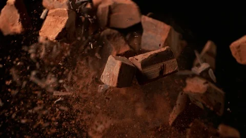 Super slow motion of flying raw chocolate pieces with ramping speed effect Stock Footage 119933523