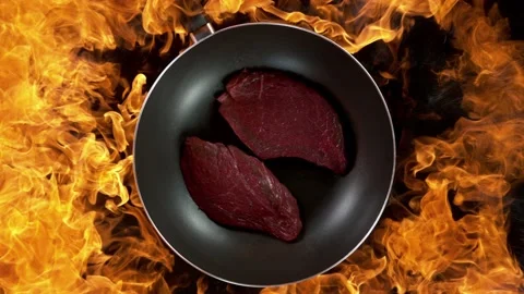 Super slow motion of flying raw beef steaks from wok pan Stock Footage 227311920