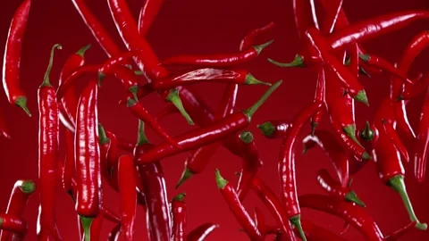 Super slow motion of flying red hot chilli peppers. Stock Footage 163787745