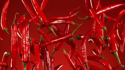 Super slow motion of flying red hot chilli peppers isolated. Stock Footage 252134314
