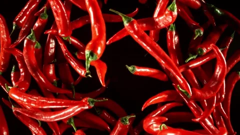 Super Slow Motion of Flying Red Chilli Peppers on Black Background. Stock Footage 282295868