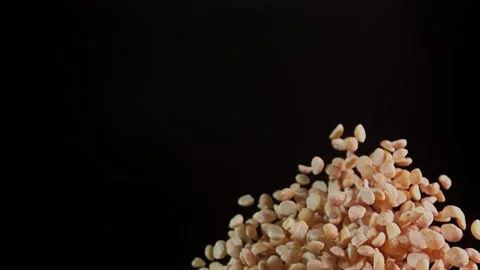 Super slow motion flying roasted peanuts. Stock Footage 280685905