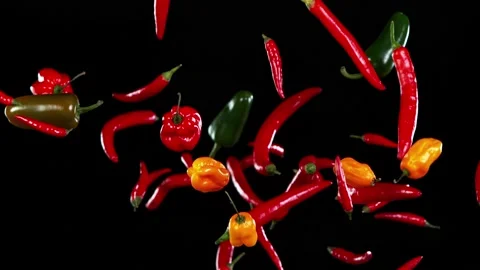 Super slow motion of flying various kinds of chilli peppers. Stock Footage 163766999