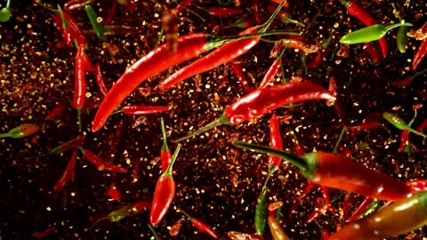 Super slow motion of flying various kinds of chilli peppers. Stock Footage 282439962