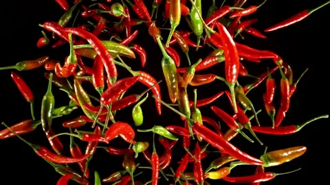Super slow motion of flying various kinds of chilli peppers. Stock Footage 282440054