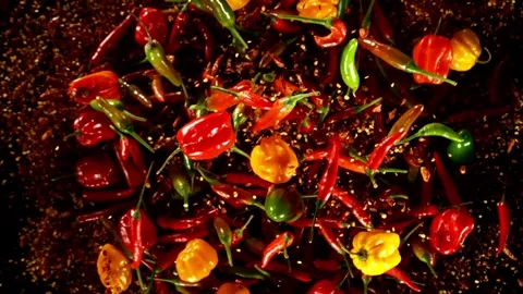 Super slow motion of flying various kinds of chilli peppers. Stock Footage 282440094