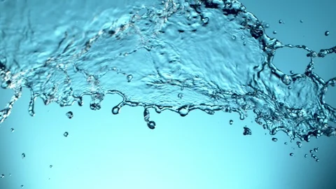 Super slow motion of flying water splash on soft blue background Stock Footage 118697019