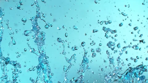 Super Slow Motion of Flying Water Splashes, Isolated on Blue Background. Stock Footage 295447174