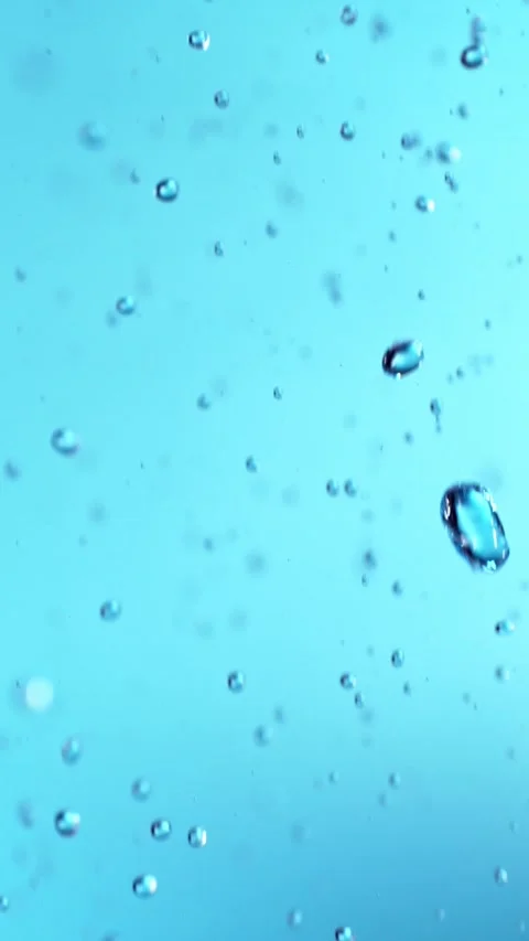 Super Slow Motion of Flying Water Drops, Isolated on Blue Background. Stock Footage 295943868