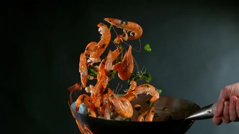 Super slow motion of flying whole prawns from wok pan Stock Footage 168834801