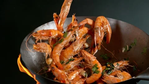 Super slow motion of flying whole prawns from wok pan Stock Footage 168836072