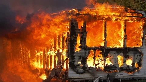 Super slow motion footage of massive flames burning a trailer home. Large house Stock Footage 232337476