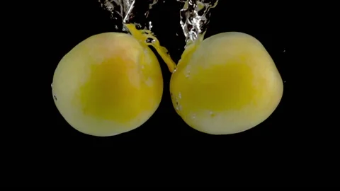 Super slow motion, fresh apricots fall into the water with air bubbles Stock Footage 196664644