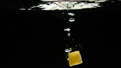Super slow motion of fresh mango and pineapple falling into water on black Stock Footage 256301073