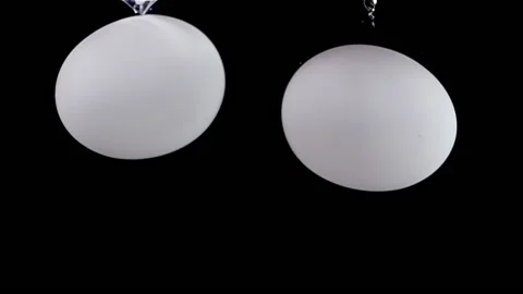 Super slow motion fresh white two eggs fall into the water with air bubbles. Stock Footage 196223199