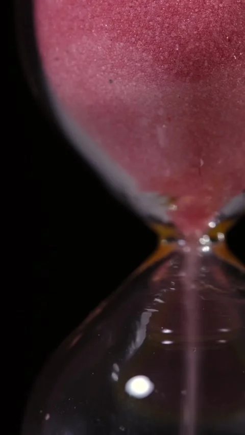Super slow motion, Gentle Cascade Of Pink Sand In Glass Reminding Us Of Time Stock Footage 330110988