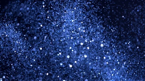 Super slow motion of glittering blue particles on black background Stock Footage 94686589