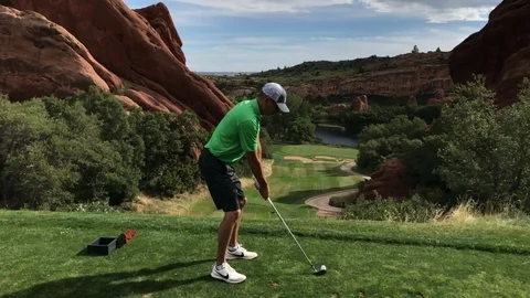 Super slow motion of golfer hitting golf ball on scenic par 3 in Colorado Stock Footage 95411786