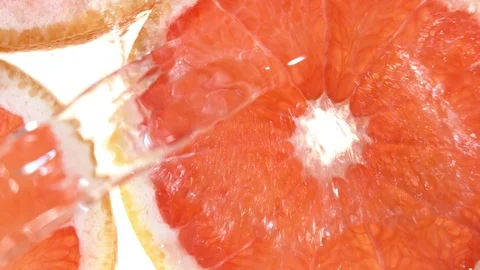 Super slow motion of grapefruit slices with water splash Stock Footage 107523304