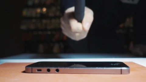 Super slow motion guy smashes a phone display hammer Stock Footage 93522811