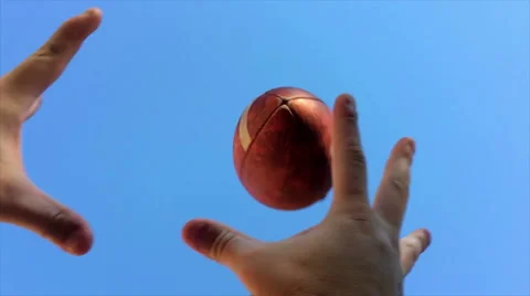 Super slow motion of hands catching football Stock Footage