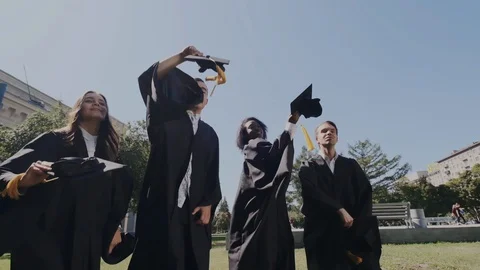 Super slow motion. Happy mixed races graduates standing in the University Stock Footage 116186865