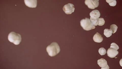 Super Slow Motion Hazelnut Flying Towards Camera on Brown Background at 1000fps. Stock Footage 265078202