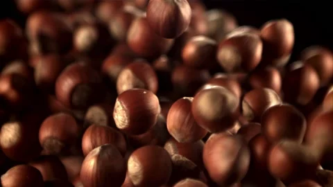 Super slow motion hazelnuts rise up and fall down. Filmed on a high-speed camera Stock Footage 156438608