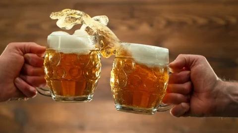 Super slow motion of hitting beer mugs together, cheers concept Stock Footage 237164064