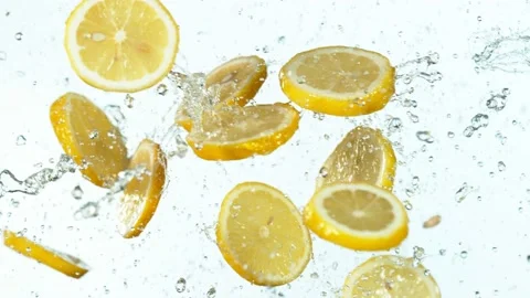 Super slow motion of lemon hitting in the air with water splashes. Stock Footage 138652655