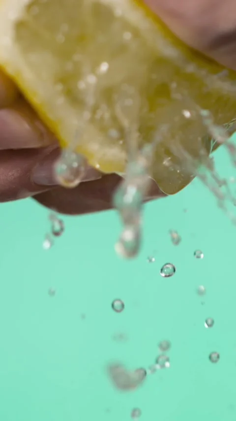 Super Slow Motion Lemon Squeeze Droplet On Aqua  Stock Footage 333485165
