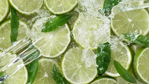 Super slow motion of lime slices with splashing water, top view Stock Footage 149756699