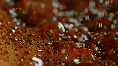 Super Slow Motion Macro Shot of Splashing Fresh Coffee and Water Droplets at Vidéo gratuite 134236795