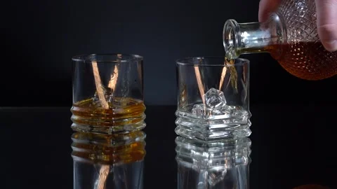Super Slow Motion Macro Shot of Pouring Whiskey into Glass with Ice Cubes Stock Footage 153467369