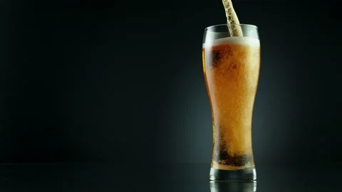 Super slow motion of macro shot of pouring beer drink, close-up. Stock Footage 157560163