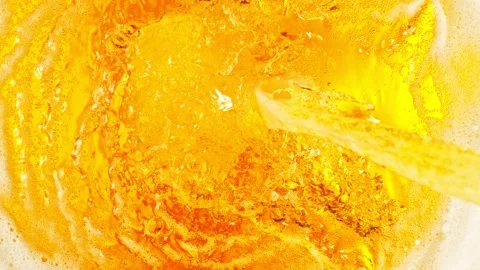 Super slow motion of macro shot of pouring beer drink, top view. Stock Footage 242082946