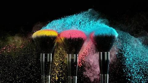 Super slow motion of makeup brushes with flying colored powder. Stock Footage 162345160