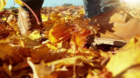 Super slow motion of man walking in autumn leaves. Stock Footage 206437848