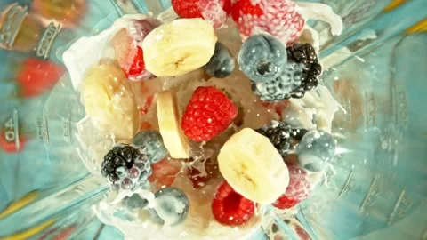 Super Slow Motion of Mixing Fruit Pieces with Milk in Blender. Stock Footage 306657818