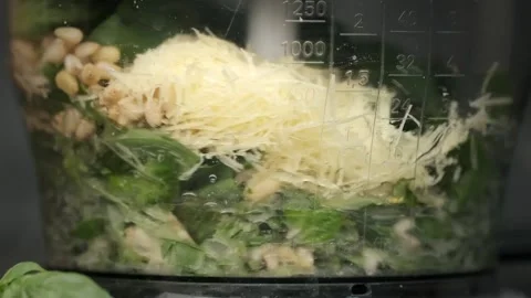 Super slow motion of mixing ingredients for pesto sauce in a blender Stock Footage 201325985