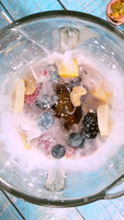 Super Slow Motion of Mixing Pieces of Fruit and Milk in Blender. Stock Footage 290299484