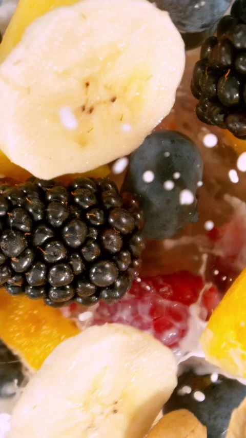 Super Slow Motion of Mixing Pieces of Fruits and Milk in Blender. Stock Footage 290299703