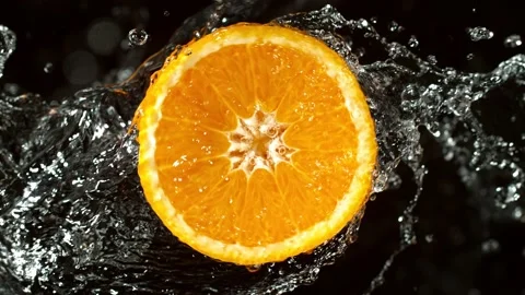 Super Slow Motion of Orange Slice With Water Splashes. Stock Footage 216648475