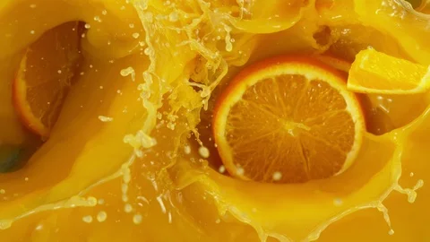 Super slow motion of orange slices falling into juice Stock Footage 124936007