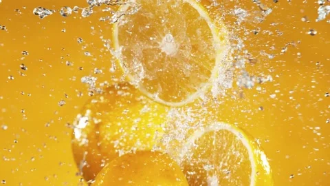 Super slow motion of orange slices collision with water splashes Stock Footage 136784116