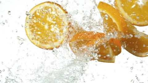 Super slow motion of orange slices hitting in the air with water splashes. Stock Footage 138651908