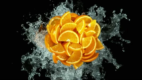 Super slow motion of orange slices with splashing water Stock Footage 223672567